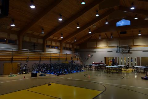 Our bikes and sleeping bags under the gradually-brightening halogen bulbs Bikes & Sleeping Bags